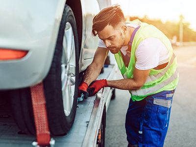 Man Assisting Towed Car — Owensboro, KY — McCarty's Auto & Truck Repair Man Assisting Towed Car — Owensboro, KY — McCarty's Auto & Truck Repair