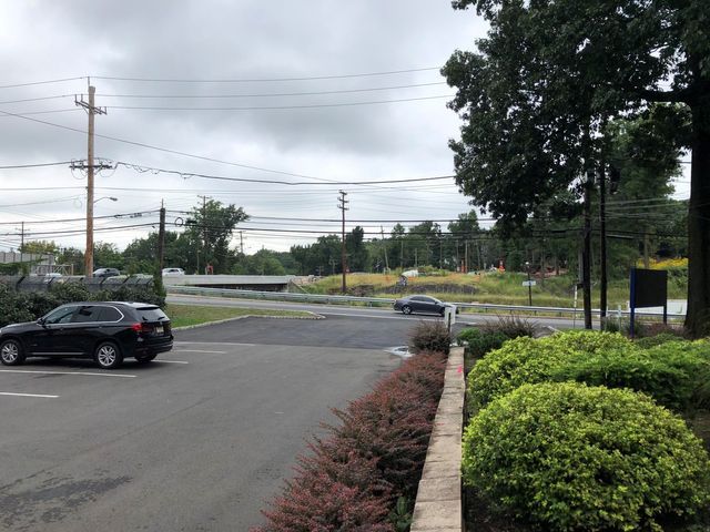 Black Vehicle On Road — Clifton, NJ — Evergreen Commercial Real Estate Brokers Inc