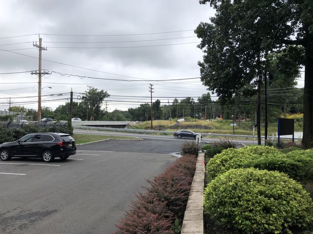 Black Vehicle On Road — Clifton, NJ — Evergreen Commercial Real Estate Brokers Inc
