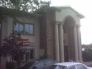 Two Cars Parked Infront Of Building With Columns — Clifton, NJ — Evergreen Commercial Real Estate Brokers Inc