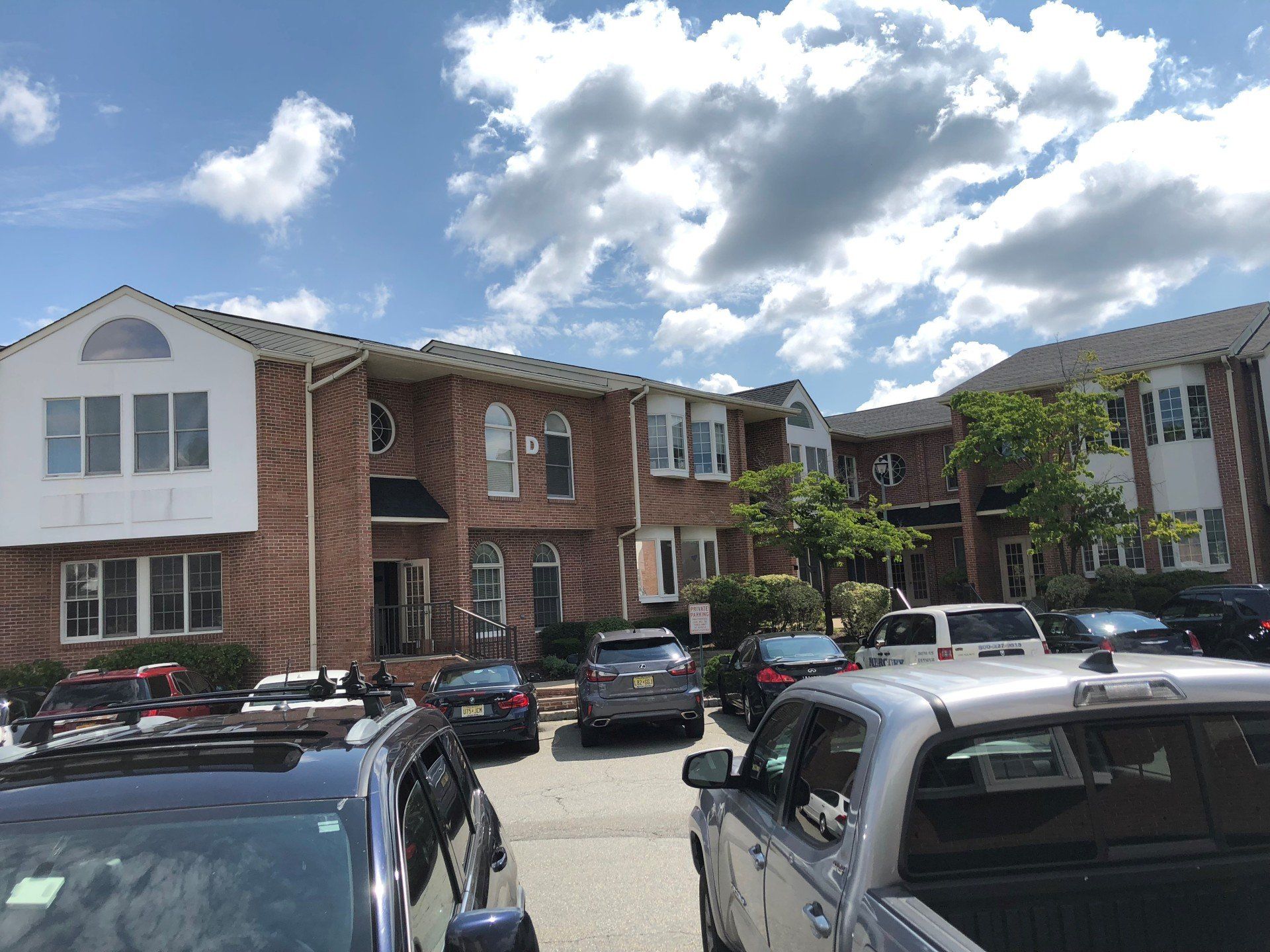 Vehicles Infront Of Huge Office Building — Clifton, NJ — Evergreen Commercial Real Estate Brokers Inc