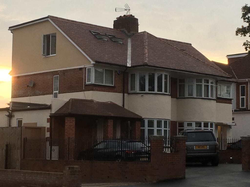 A house with a car parked in front of it