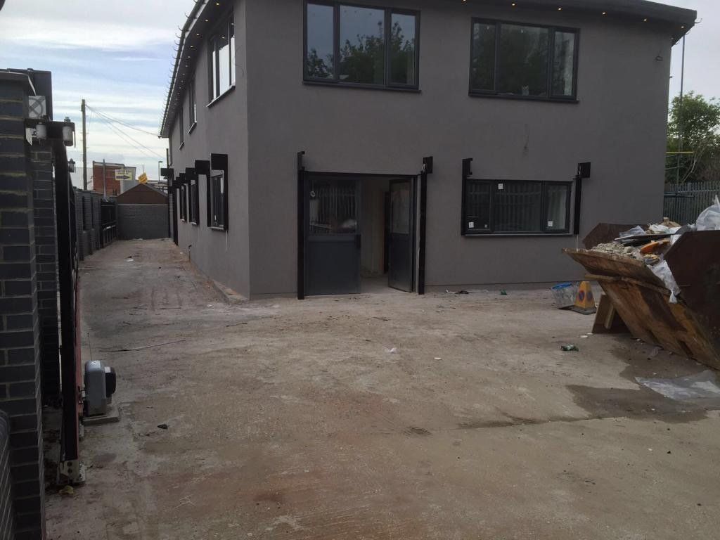 A large grey building with a lot of windows