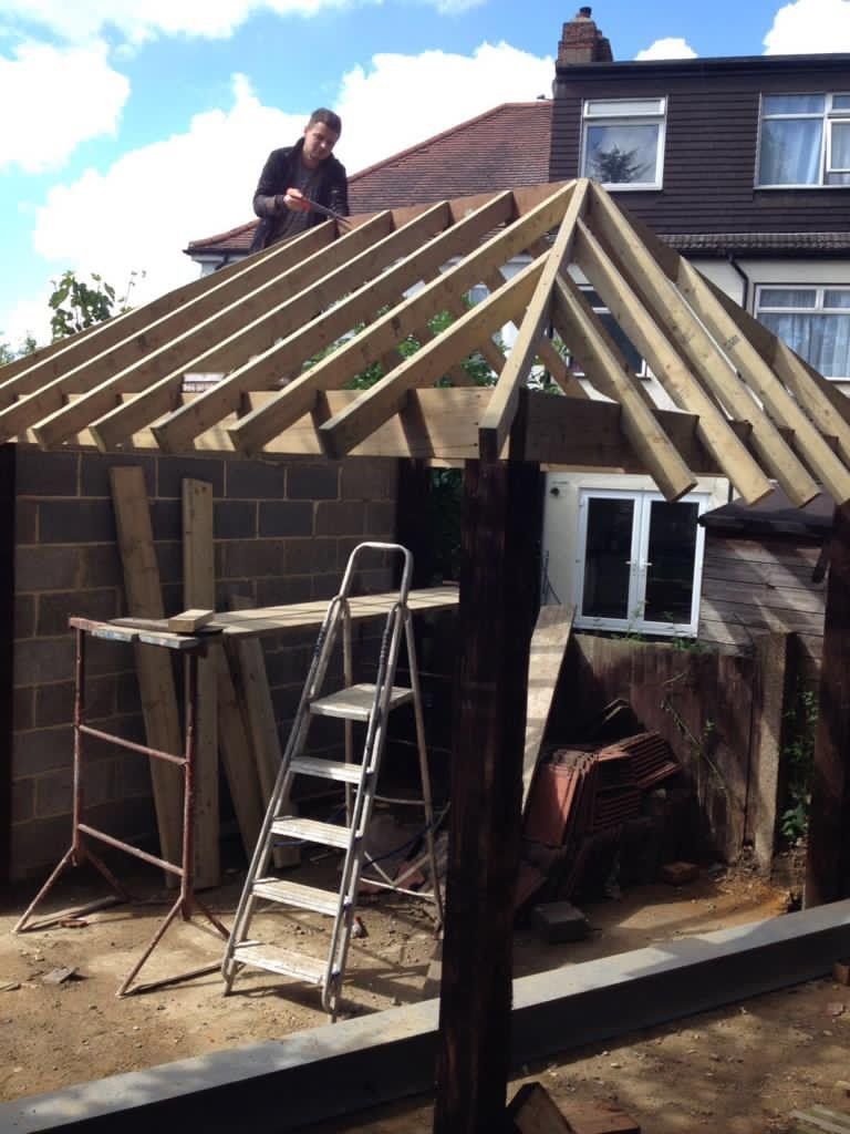 A man is working on the roof of a house