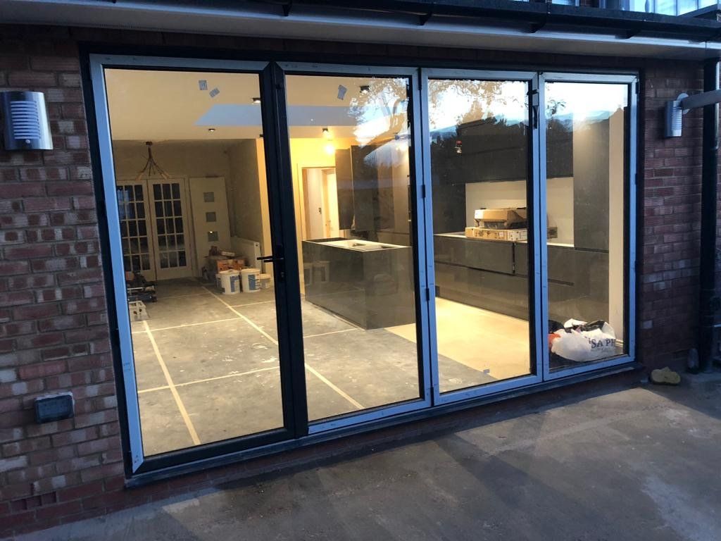 A kitchen with sliding glass doors and a brick wall.