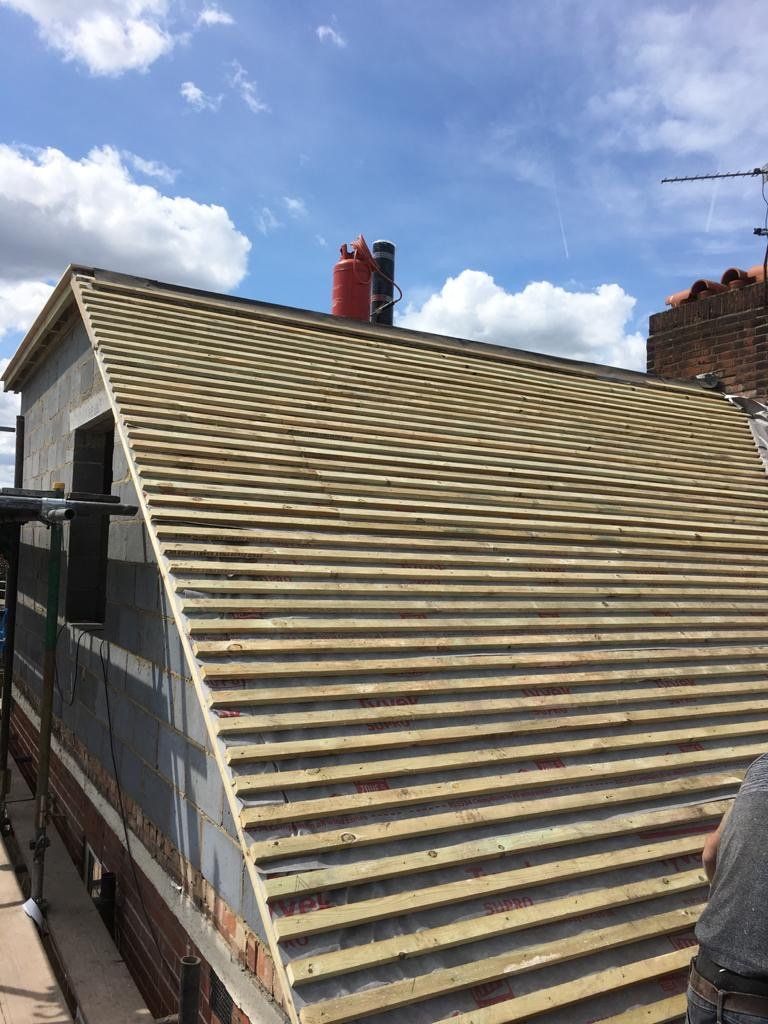 A wooden roof is being built on top of a building.