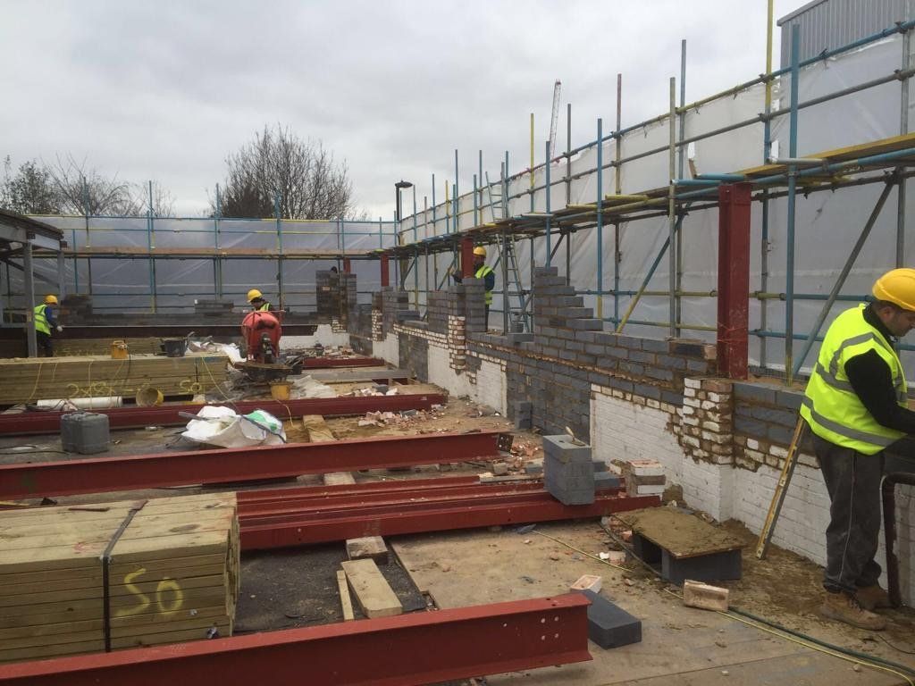 A group of construction workers are working on a building