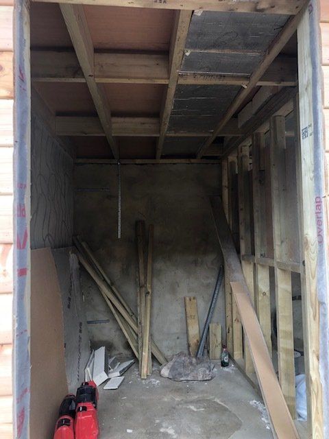 A room with a ceiling that has a few pieces of wood on it