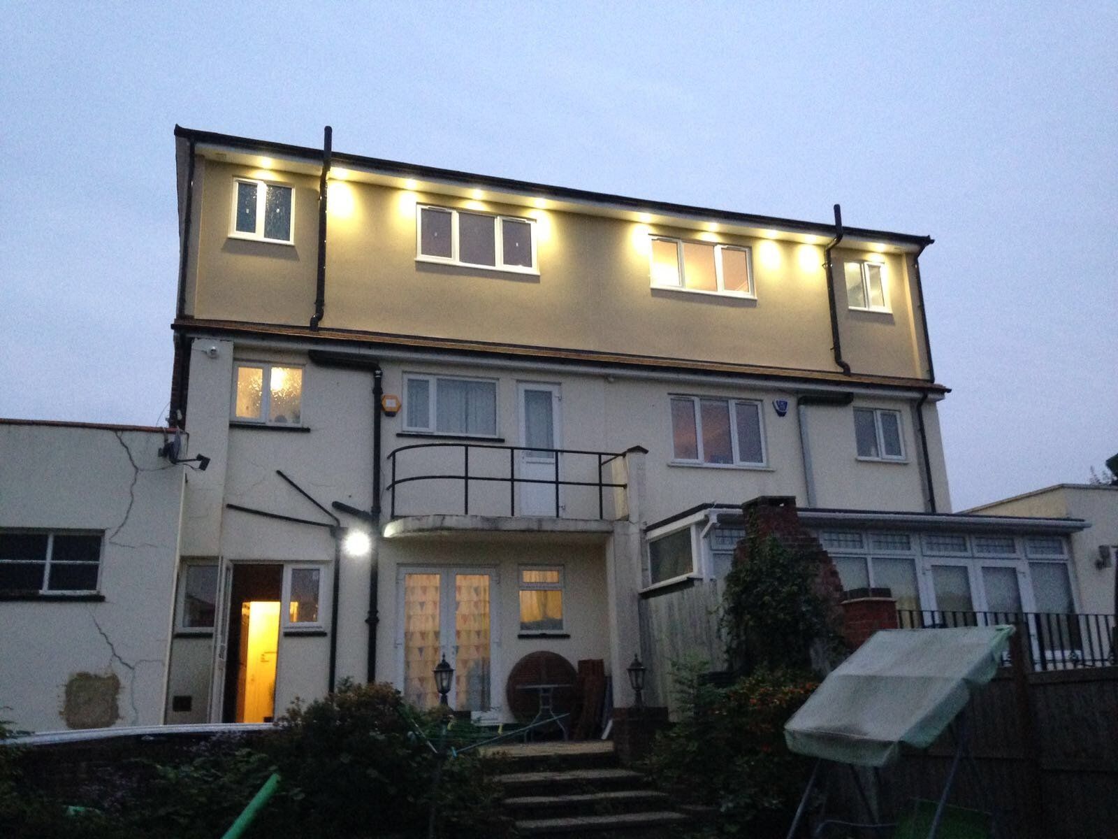 The back of a house is lit up at night