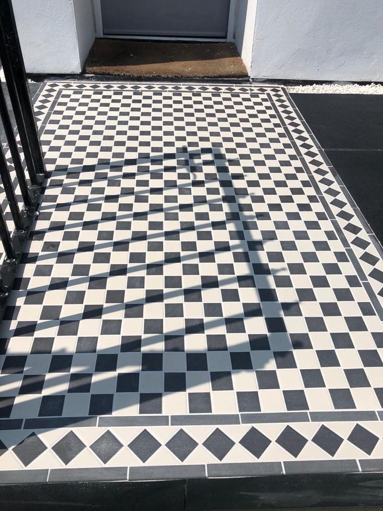 A black and white checkered floor with a shadow on it.