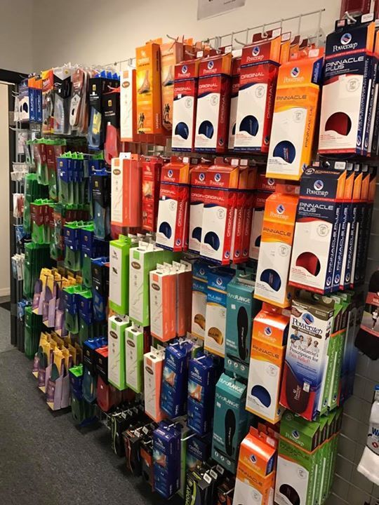 A bunch of boxes are hanging on a rack in a store