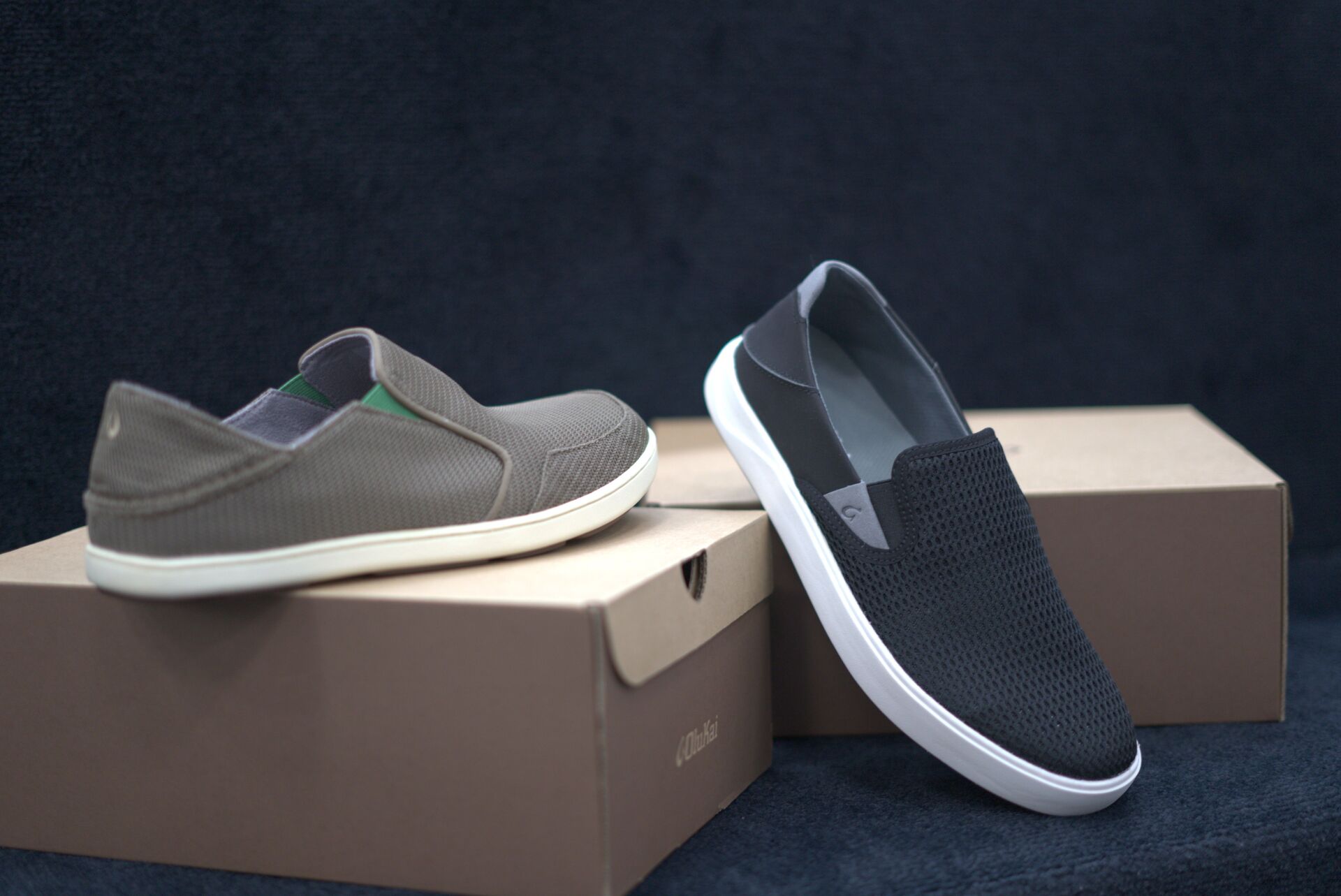 A pair of shoes sitting on top of a cardboard box.