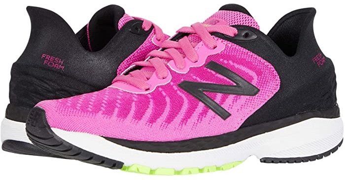 A pair of pink and black new balance running shoes on a white background.