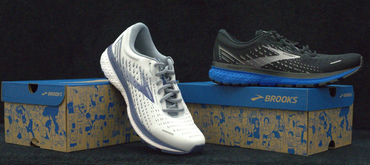 A pair of brooks running shoes sitting on top of a box
