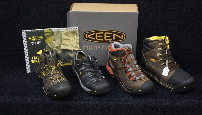 Three pairs of keen shoes are sitting next to a box