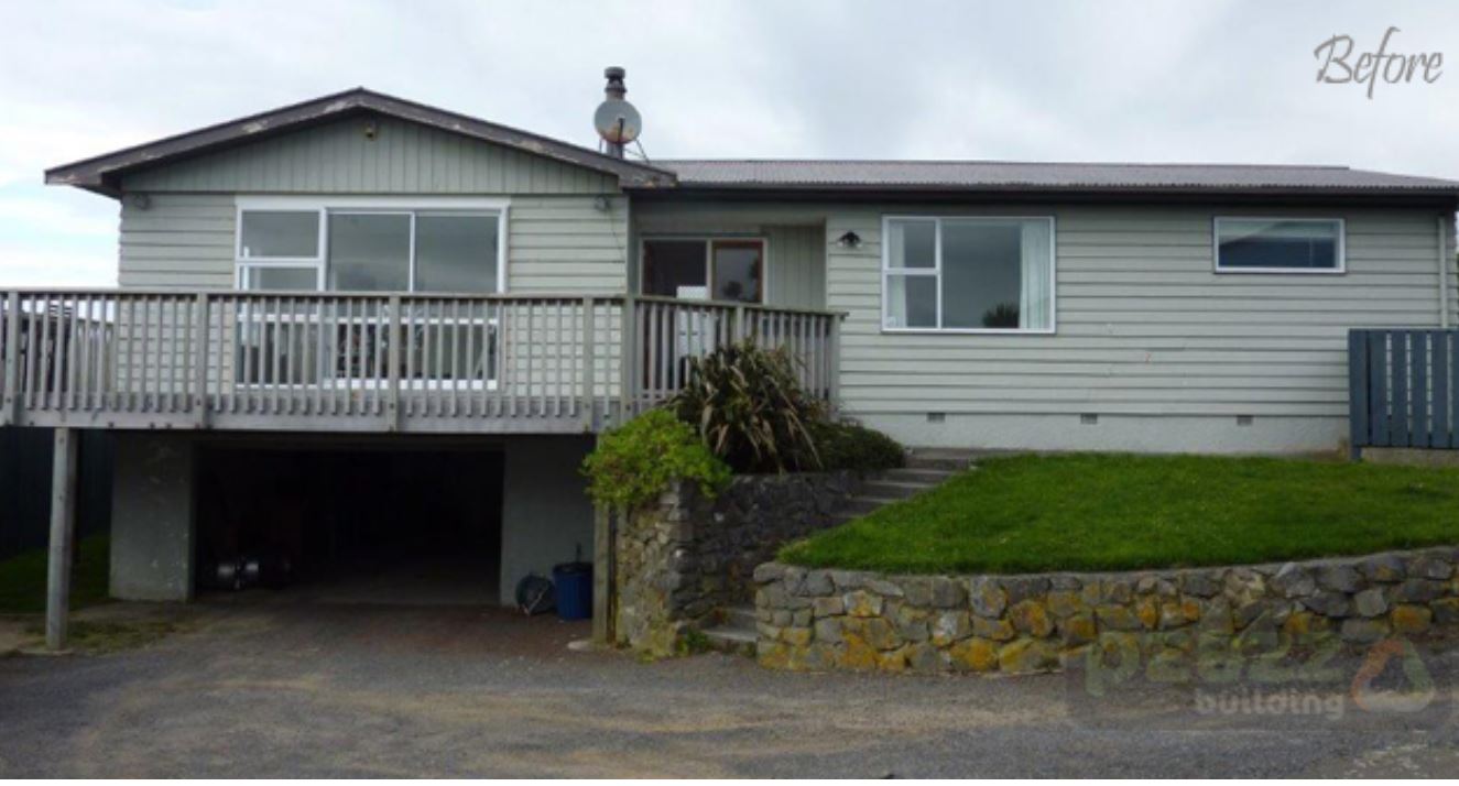 A before picture of a house with a large deck