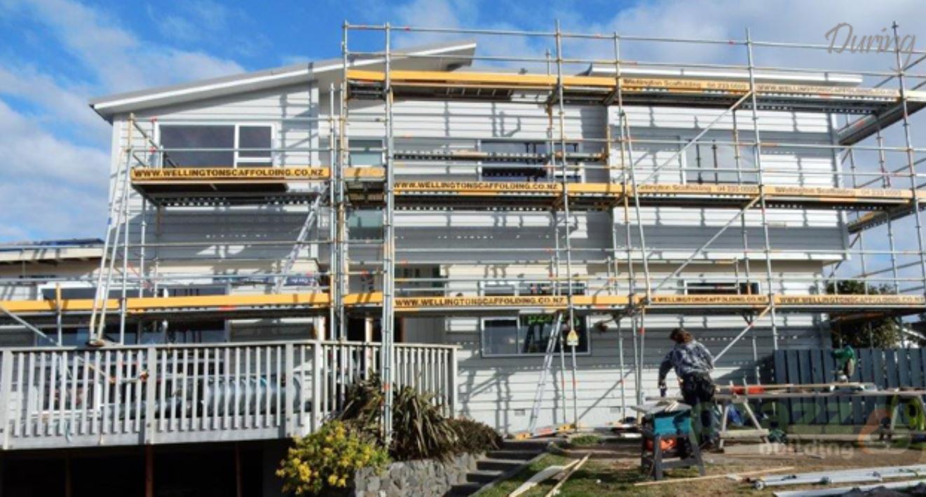 A large building with scaffolding around it is being built.