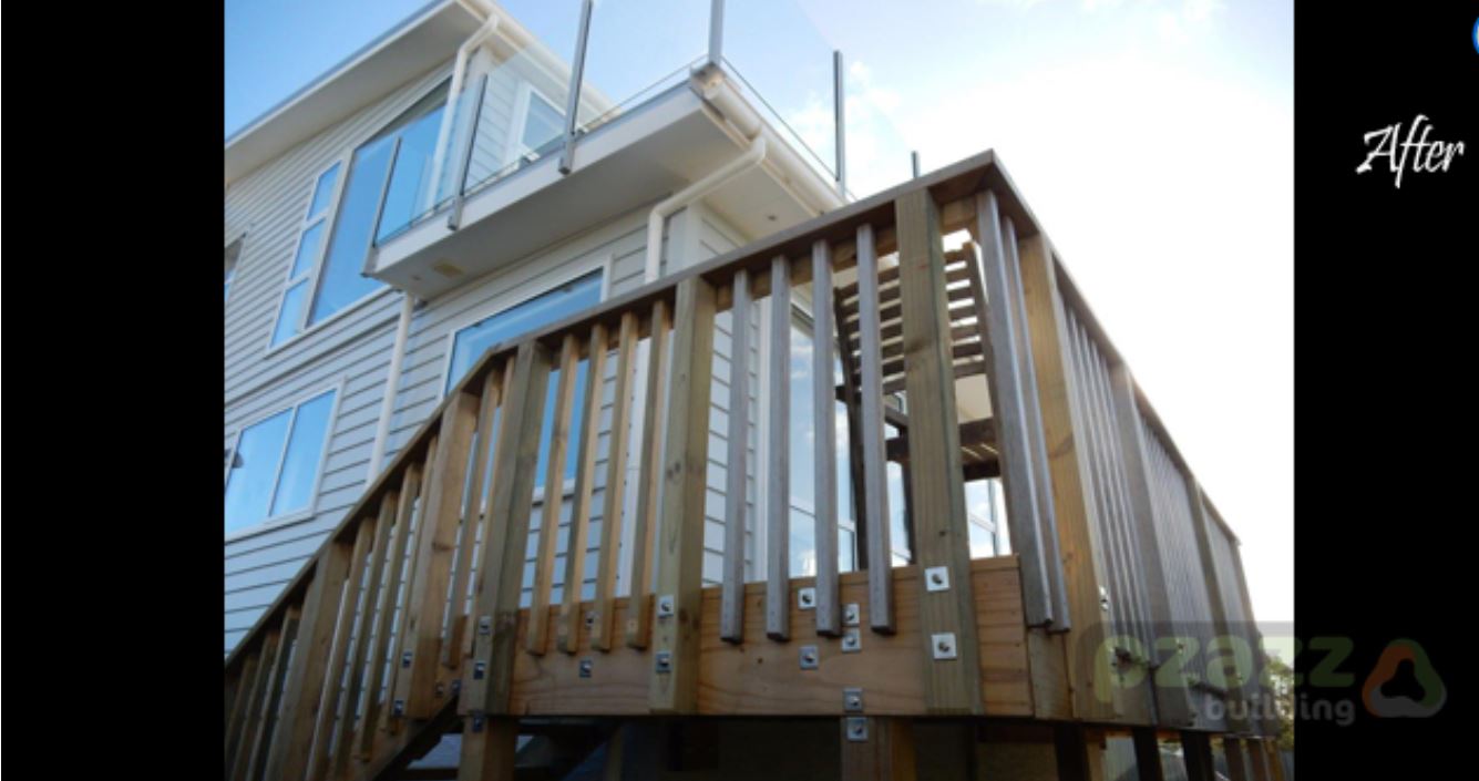 A large house with a wooden deck and stairs