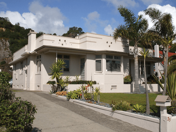 A white house with a palm tree in front of it