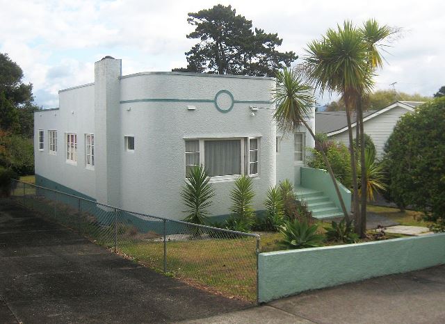 A white house with palm trees in front of it