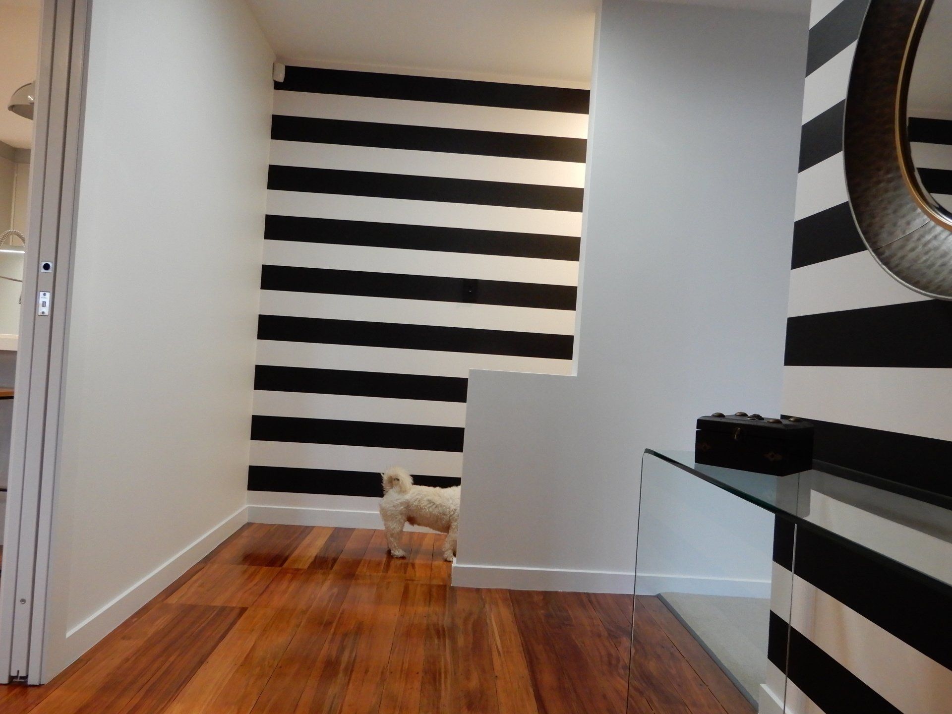 A black and white striped wall in a hallway