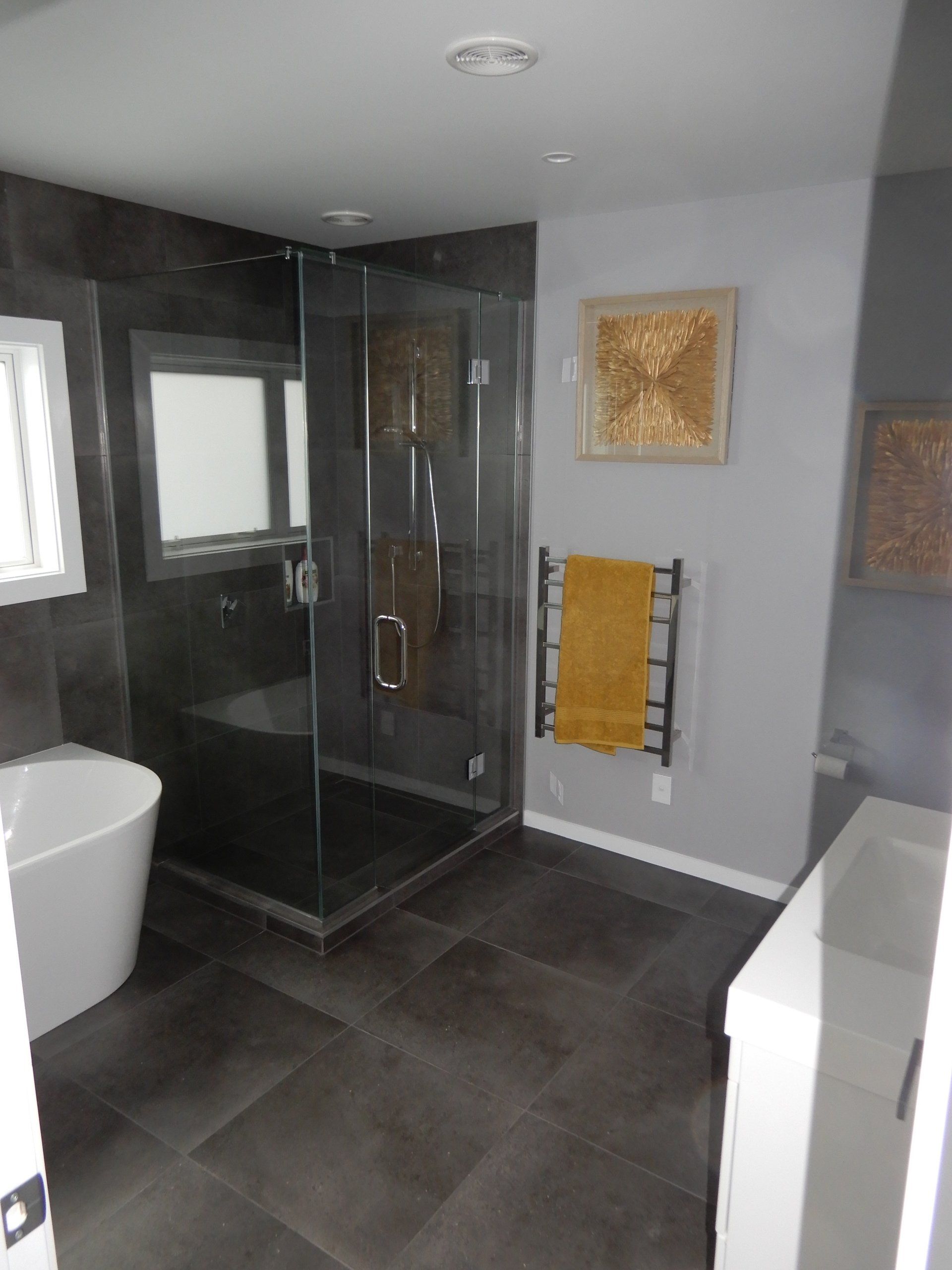 A bathroom with a bathtub and a shower stall