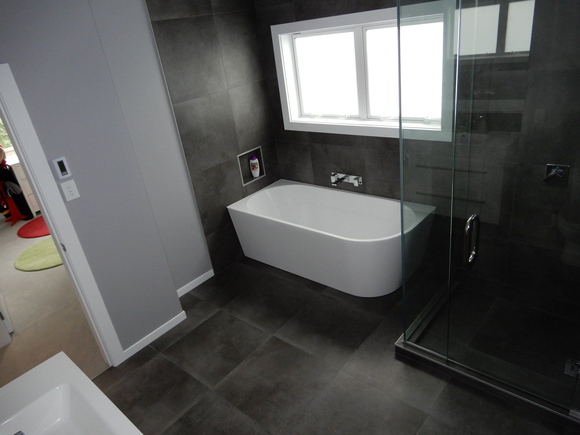A bathroom with a bathtub and a walk in shower