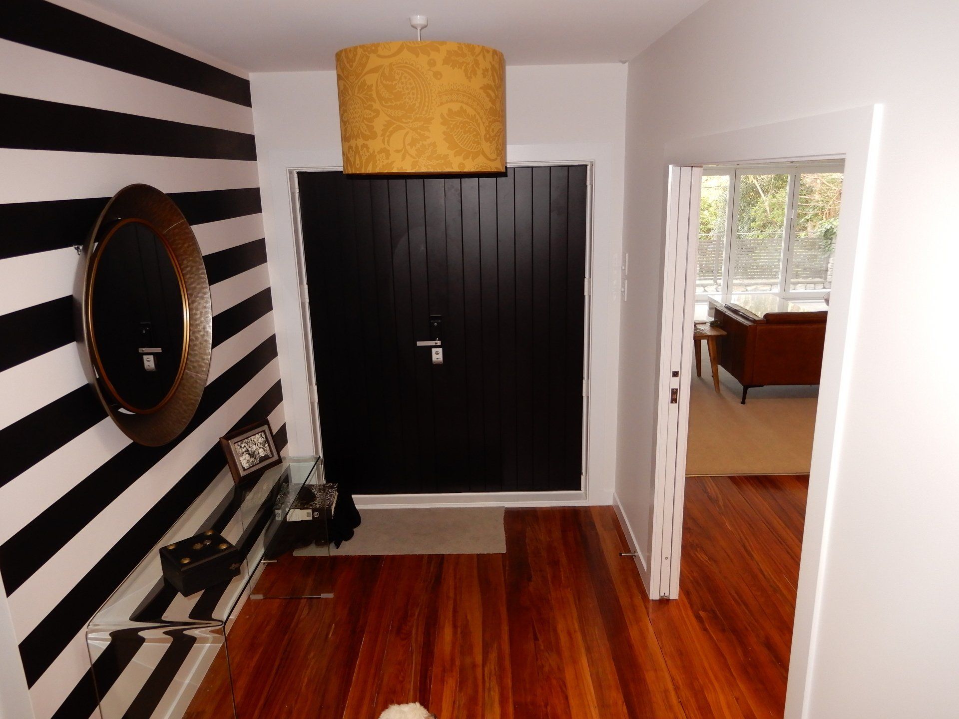 A hallway with black and white stripes on the wall