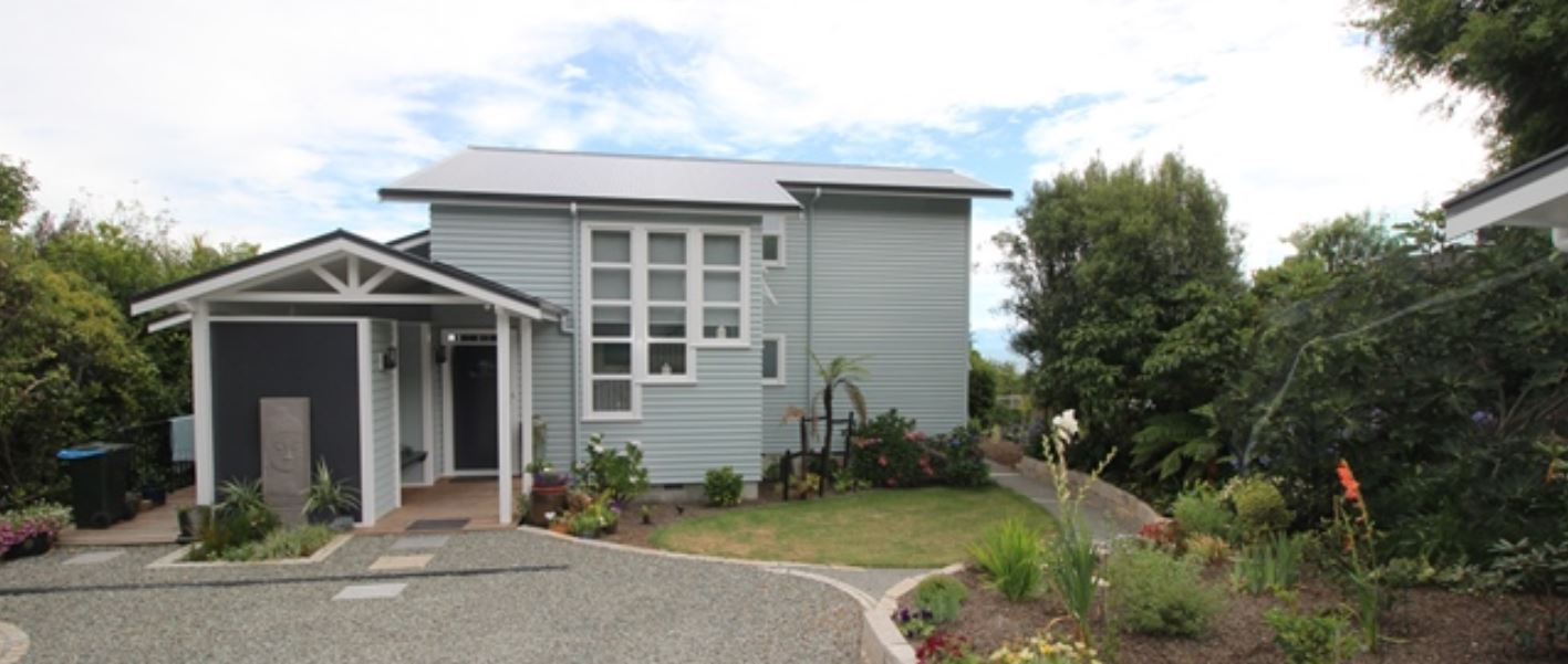 A small house with a driveway leading to it