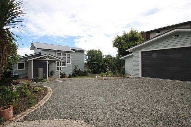 A house with a garage and a driveway in front of it