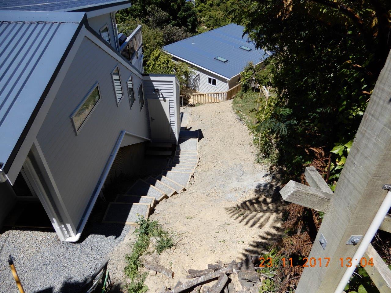 An aerial view of a house with stairs leading up to it