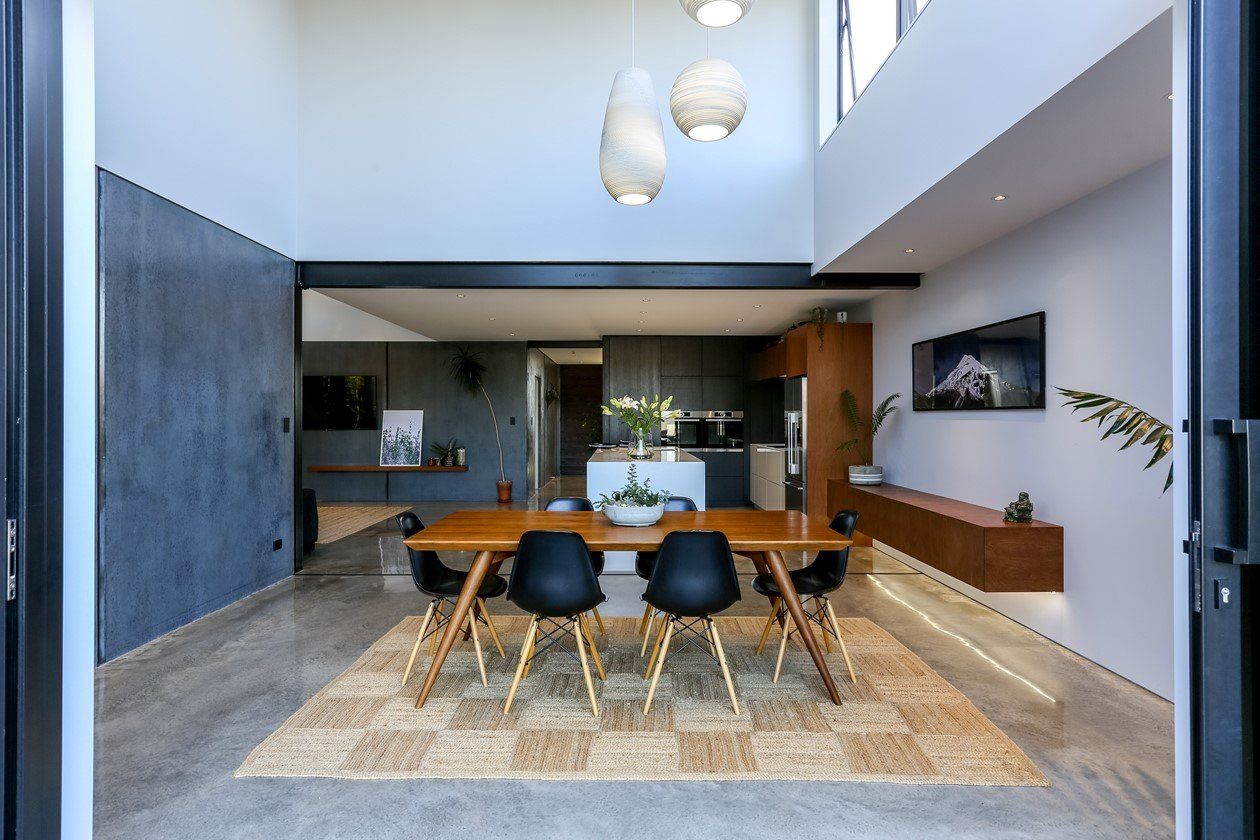 A dining room with a table and chairs in it.