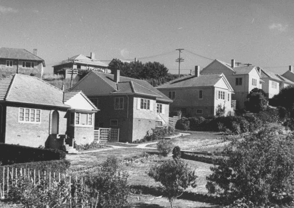 A black and white photo of a row of houses