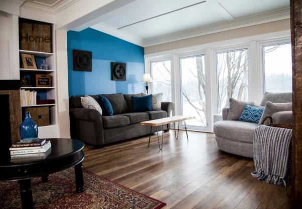 A living room with a blue wall and a couch