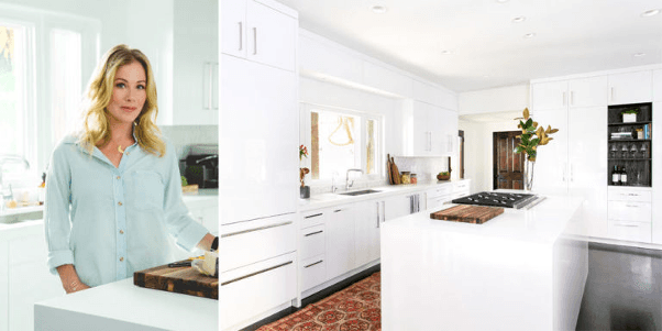 A woman is standing in a kitchen next to a picture of a kitchen.