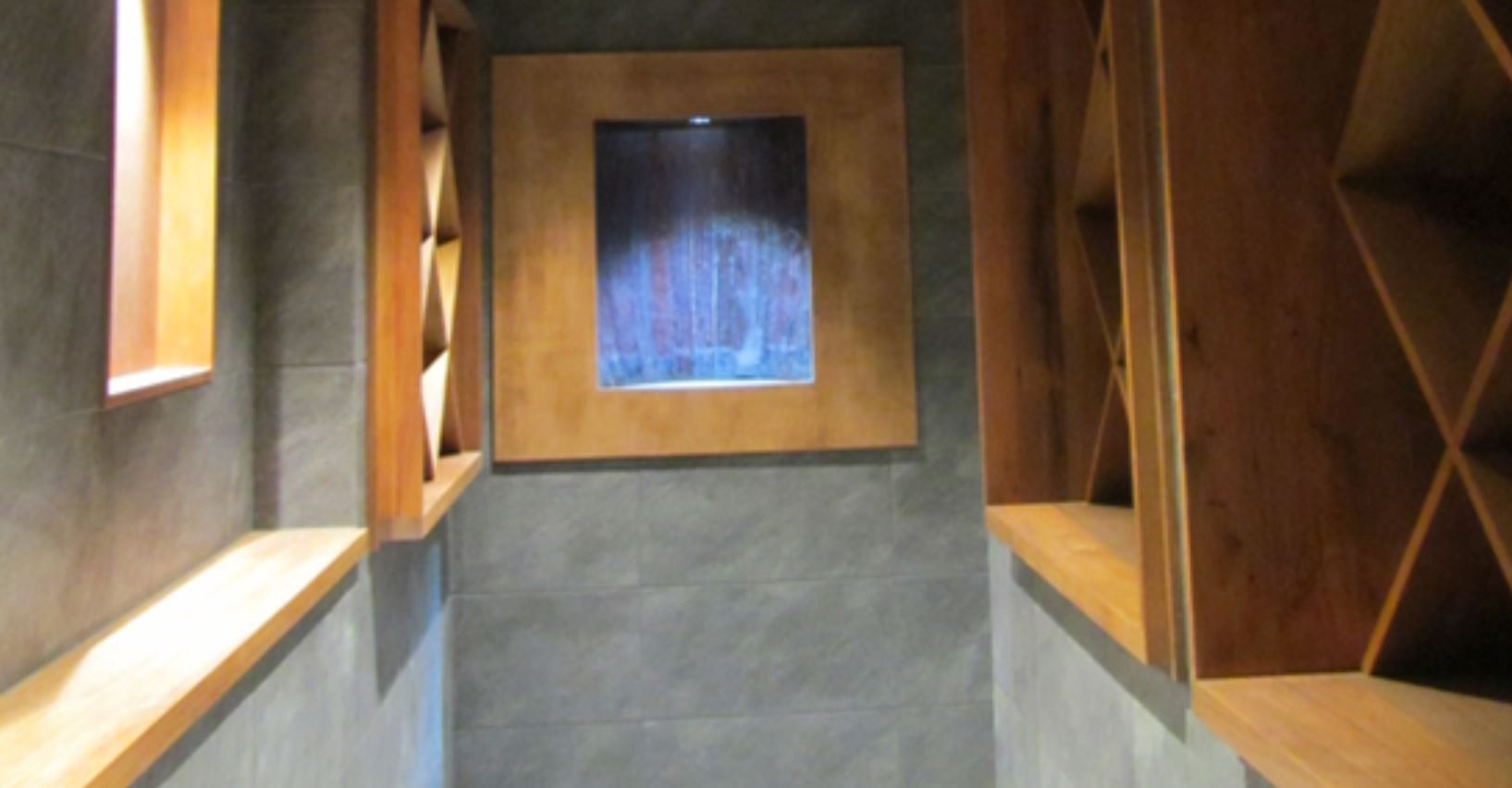 A hallway with wooden shelves and a picture on the wall