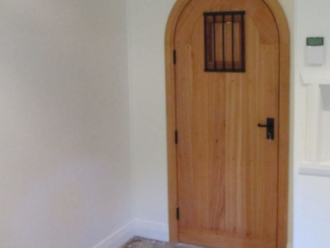 A wooden door with a small window on it