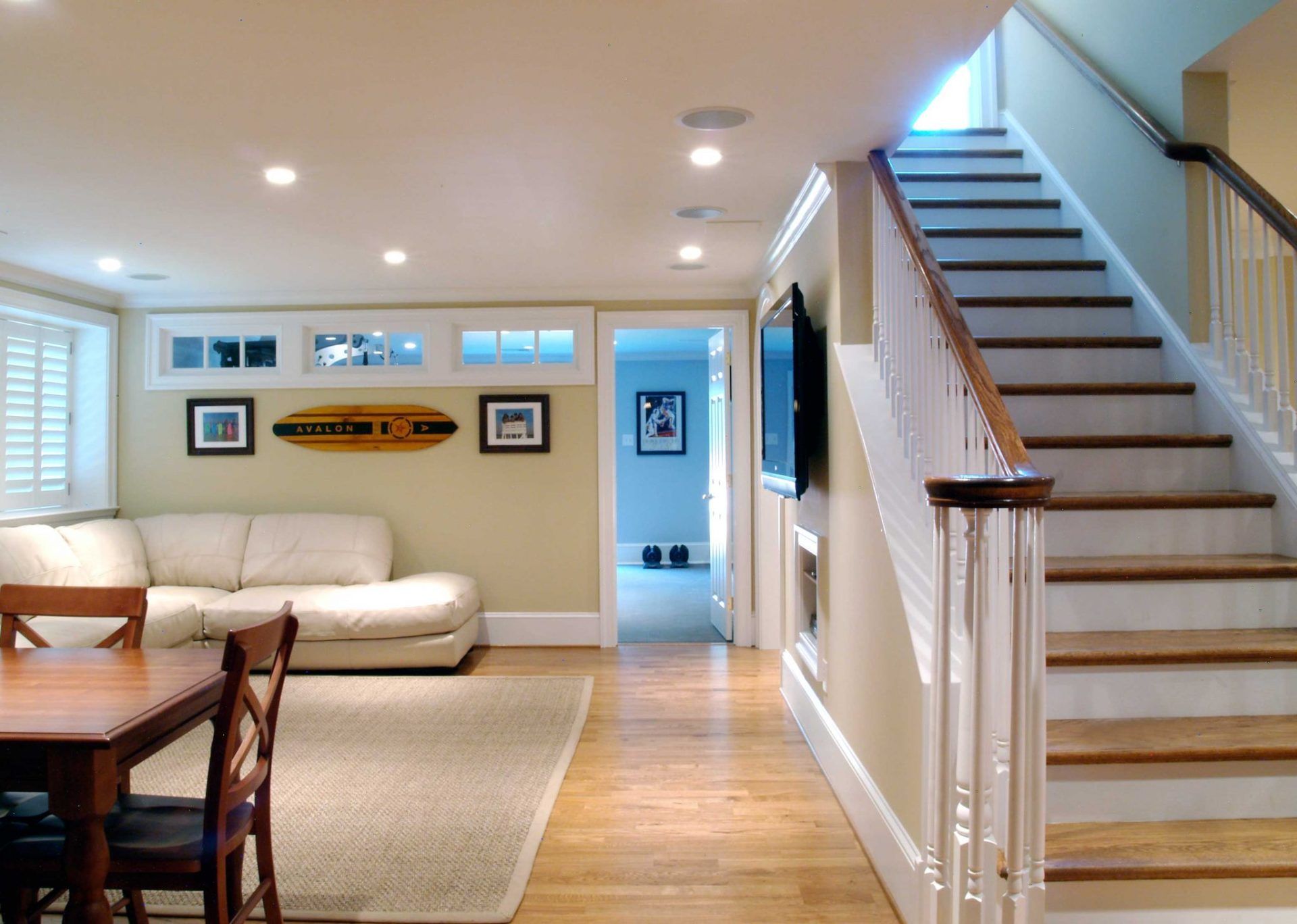 A living room with stairs leading up to the second floor
