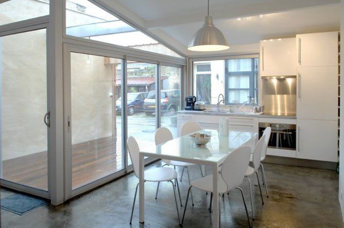 A kitchen with a table and chairs in it