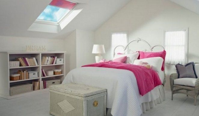 A bedroom with a skylight above the bed