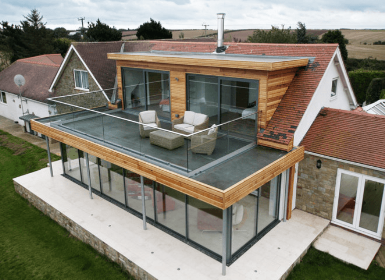 A modern house extension merges beautifully with the original home New meets old house addition
