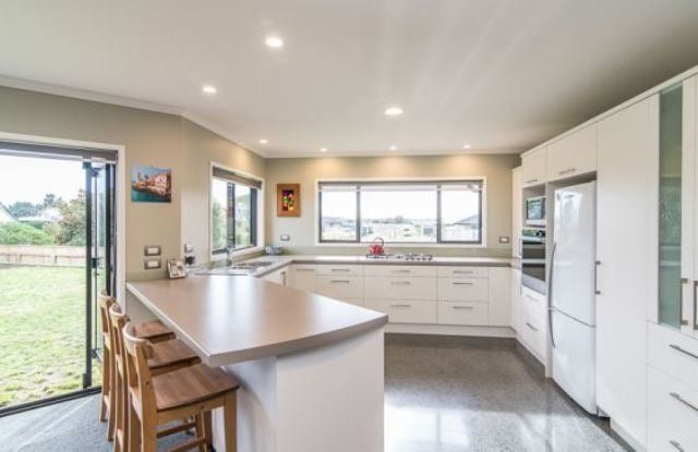 A kitchen with white cabinets and a large island