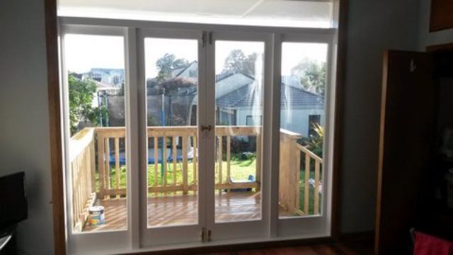 A living room with sliding glass doors leading to a deck.