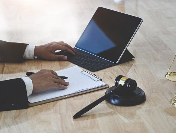 Lawyer Using Tablet on Table — Cleburne, TX — Bradley Law Firm