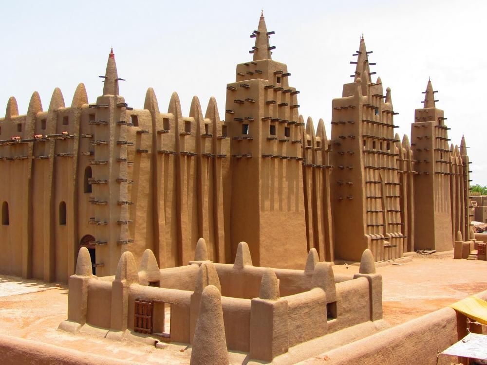 A large sand castle with a lot of towers