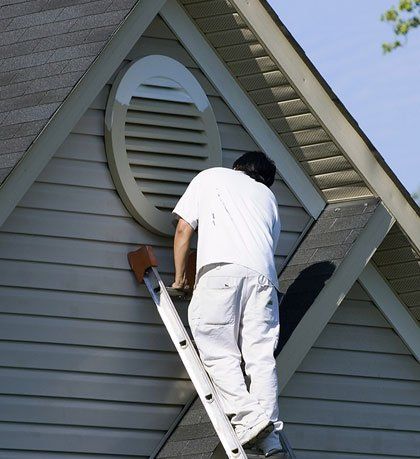 Roof Painting — Painter Working at Roofline in Seattle, Washington Roof Painting — Painter Working at Roofline in Seattle, Washington