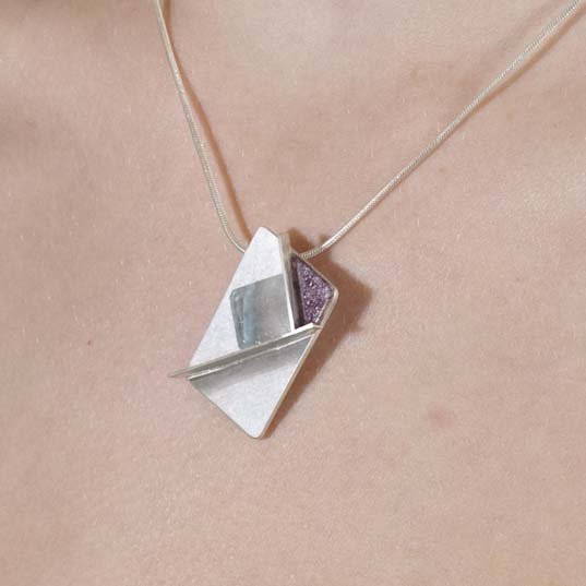 Maps silver, quartz, wood architectural pendant on model ©Libby Day Design