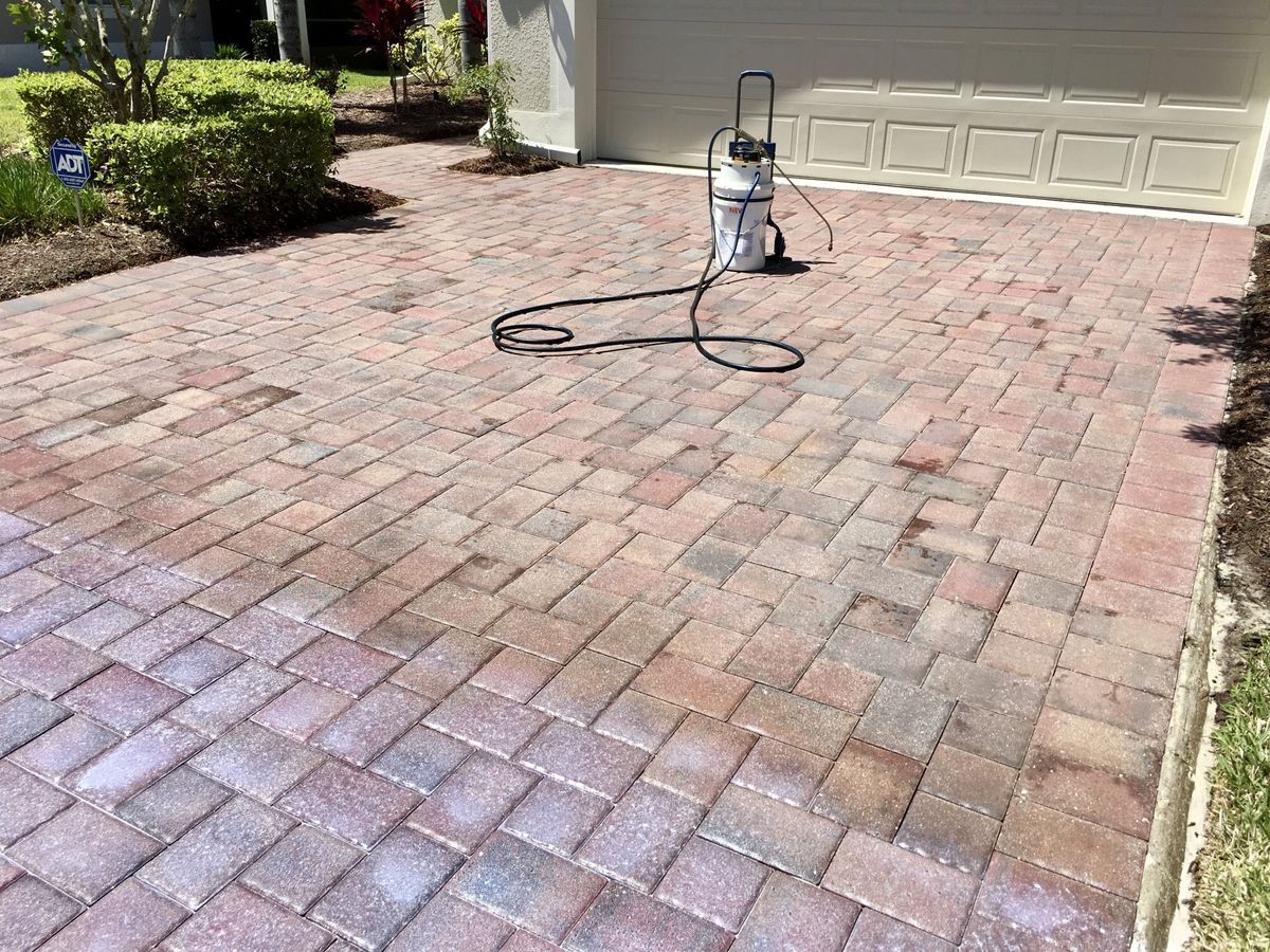 stone driveway being sealed