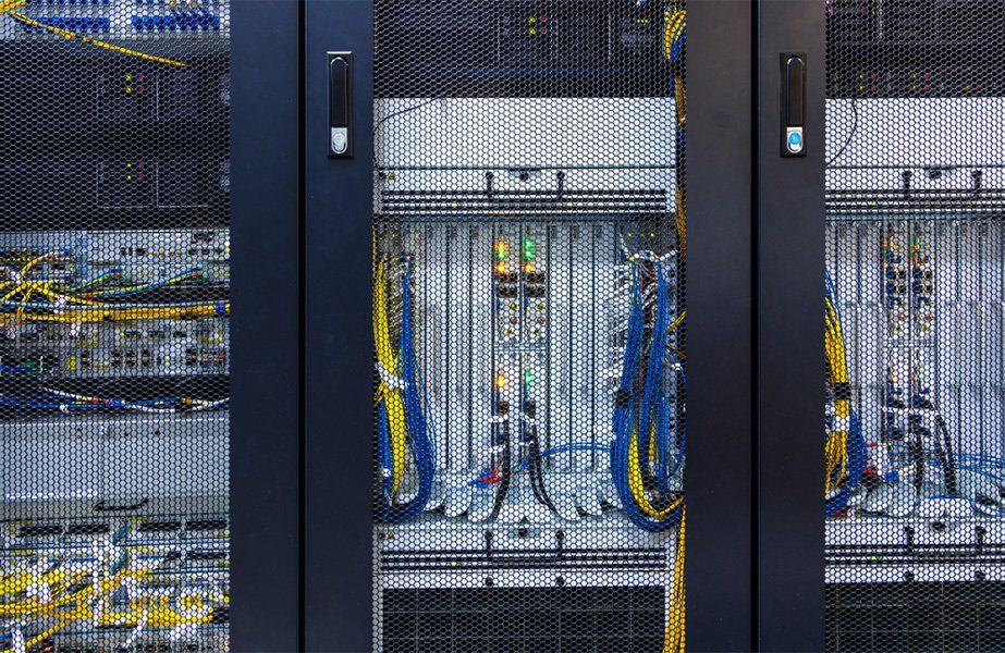 Inside cabinet with switchboard and other telecommunication mobile network hardware equipment with many cables
