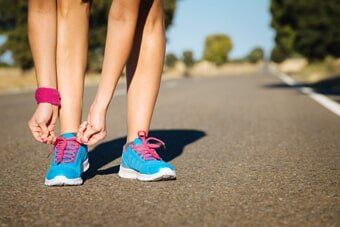 Athlete tying sportshoes laces – Personalized Orthopedics ni Albany, NY Athlete tying sportshoes laces – Personalized Orthopedics ni Albany, NY